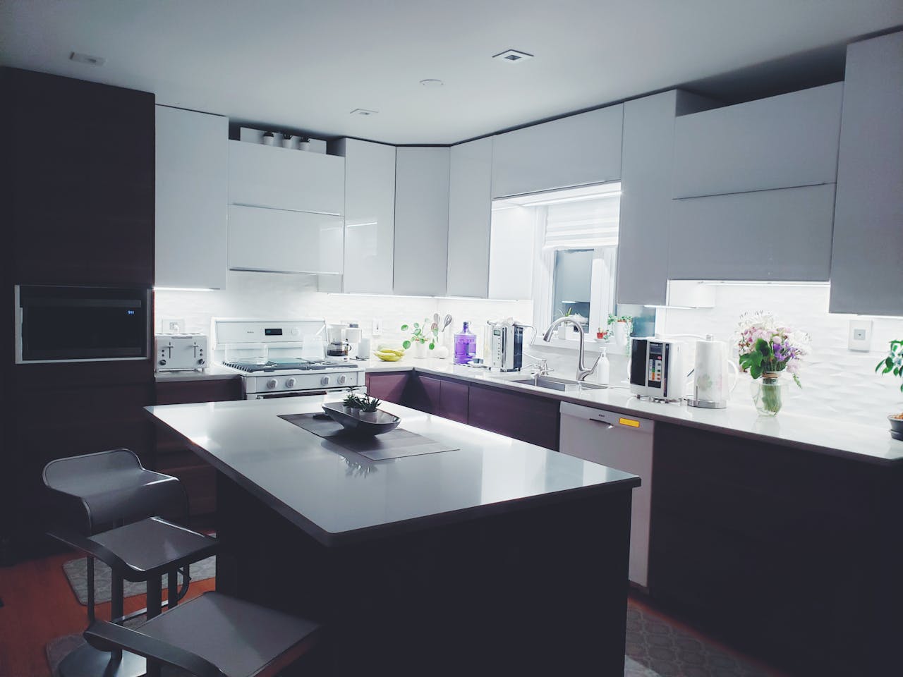 about-us Contemporary kitchen interior with sleek white cabinets and island, perfect for a minimalist aesthetic.